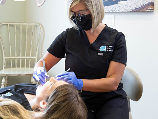 Dentist examining a patients mouth