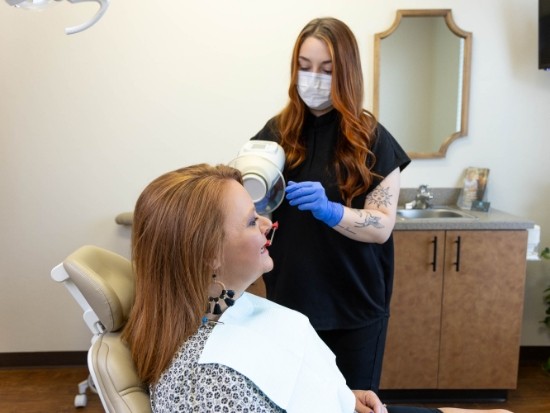 Female dentist treating a red haired patient