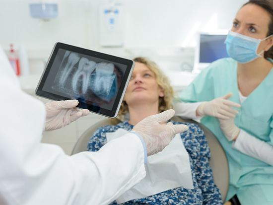 Dentist going over X-rays with patient