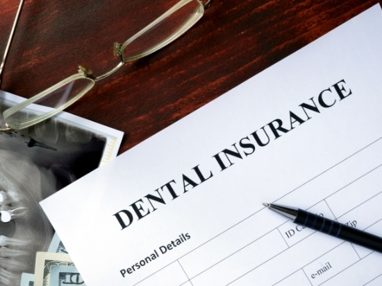 Dental insurance form on table with glasses and x ray