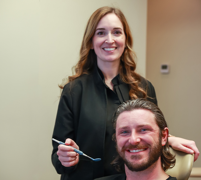 Dentist and dental patient smiling