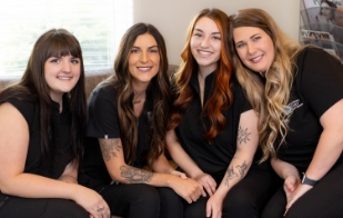 Dental team sitting on couch and smiling