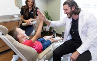 Dentist giving child patient a high five