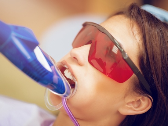 Patient with protective eyewear receiving fluoride treatment