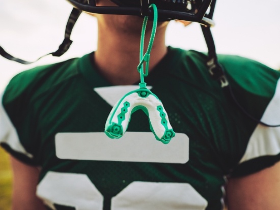 Close up of mouthguard dangling from football helmet