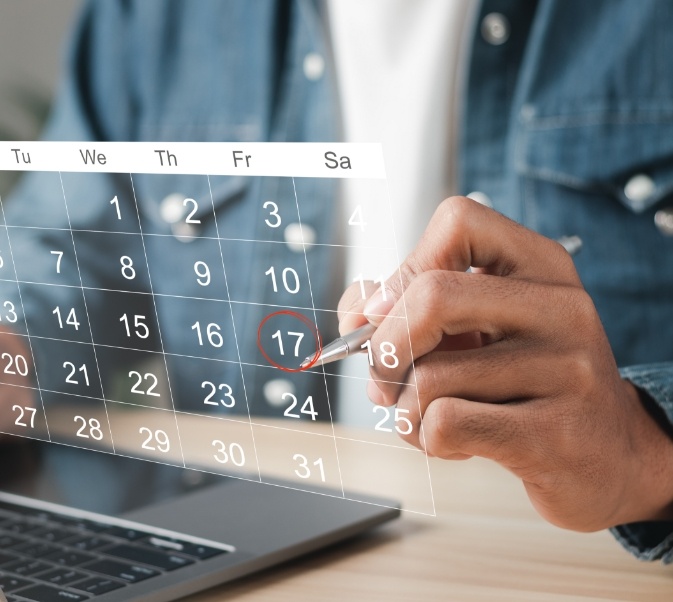 Man looking at virtual calendar and circling a date