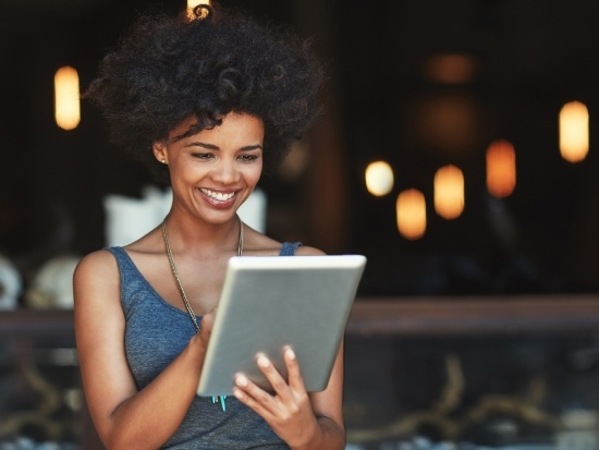 Smiling woman looking at a tablet