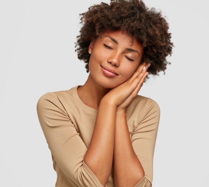 Woman resting her face against her hands