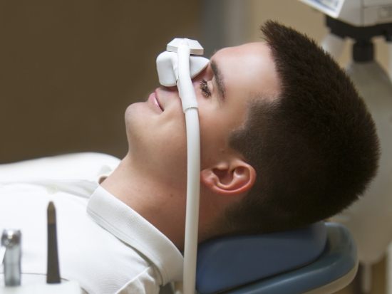 Male dental patient wearing mask for nitrous oxide sedation in El Reno