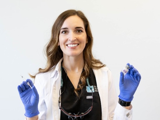 Smiling dentist with blue rubber gloves